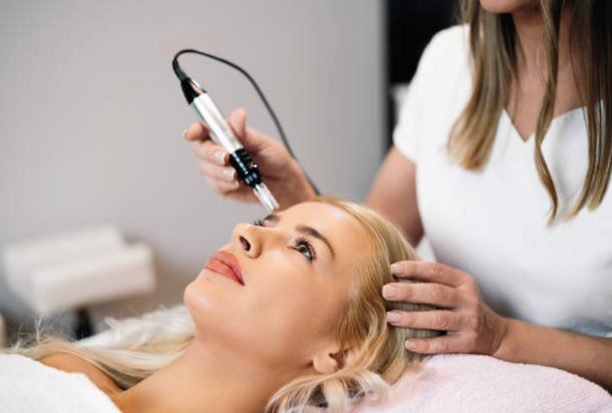 Close up shot of cosmetologist making mesotherapy injection with dermapen on face for effective skin rejuvenation. Modern cosmetology spa treatment.